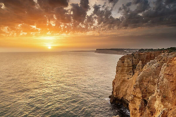 Dramatic sunset clouds over Cliffs along the coast at Ponta da Piedade in Lagos, Portugal