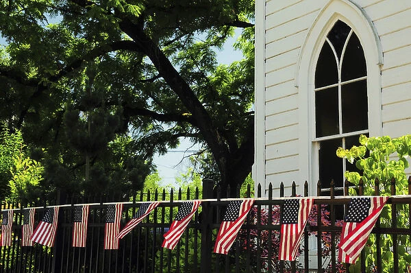 Draped flags on fence of church, July 4th; Parade; Ridgefield; Washington; USA
