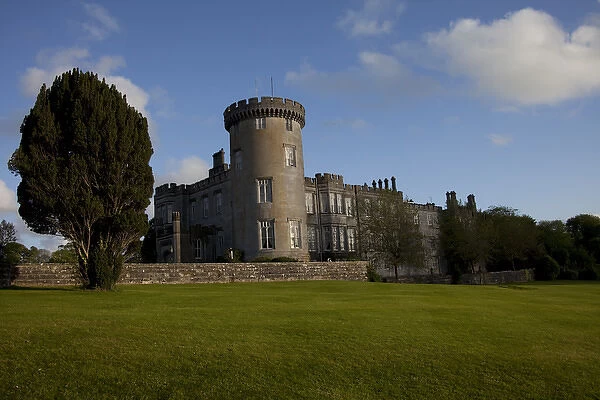 Dromoland Castle Hotel in Newmaket-on-Fergus, Ireland, side view with a large lawn