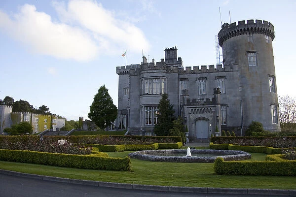 Dromoland Castle Hotel in Newmaket-on-Fergus, Ireland, side view with a fountain, shrubs