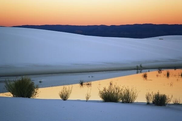 Dusk sky reflected in pool of water from recent rains, White Sands National Monument