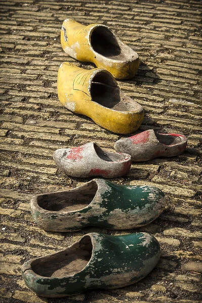 Dutch wooden shoes lined up on a stone path