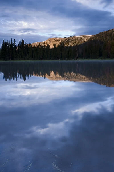 Early light hits Haystack Mountain and is reflected in a mountain lake - Uinta Mountains