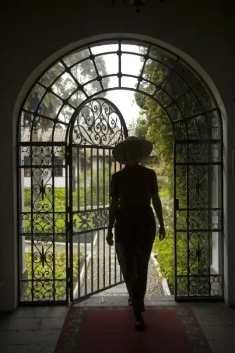 Framed Print : Ecuador, Lasso, woman in arch with wrought-iron door to garden, Hacienda La Cienega (MR) Framed Print : Ecuador, Lasso, woman in arch with wrought-iron door to garden, Hacienda La Cienega (MR)