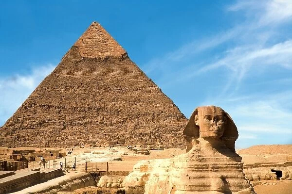 Egypt, Cairo, The Sphinx sits before and the Great Pyramid of Khufu (Cheops)
