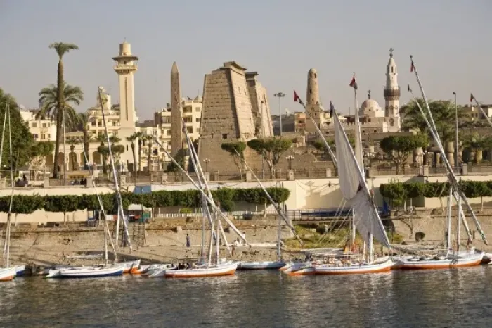 Framed Print : Egypt, Luxor. Tall-masted felucca sailboats moored on the banks for the Nile in front Framed Print : Egypt, Luxor. Tall-masted felucca sailboats moored on the banks for the Nile in front