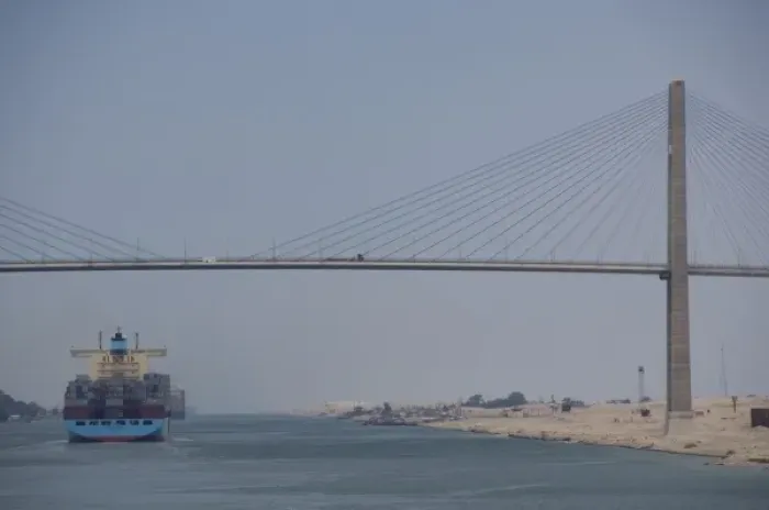 Framed Print : Egypt, Suez Canal. Cargo ship passing under Bridge of Peace (aka Peace Bridge)