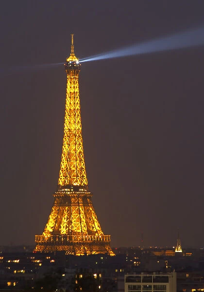 The Eiffel Twoer in Paris illuminated at night against a dark blue black sky, search