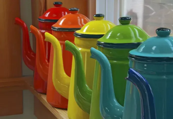 Framed Print : Enamelware coffee pots in orderly row on window sill
