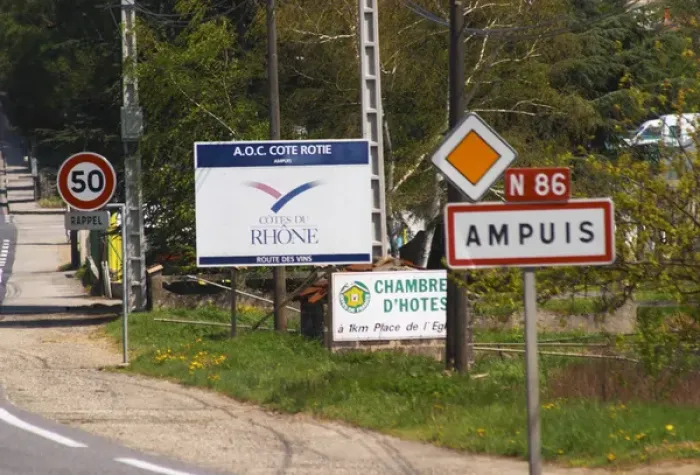 Framed Print : The entrance to Ampuis with road signs with the name of the town and a big sign saying