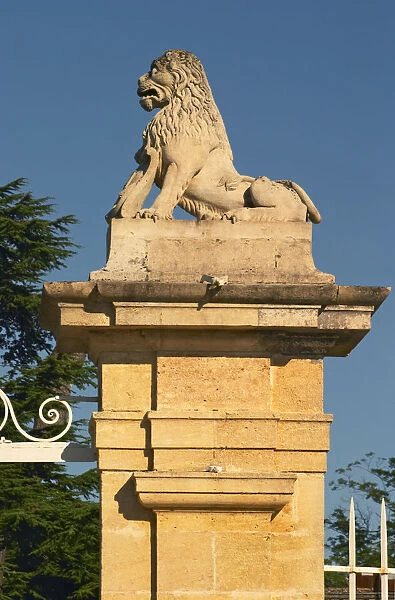 The entrance gate to Chateau Beychevelle in Saint Julien. Lion statue on the gate post
