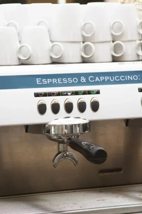 Framed Print : Espresso and Cappuccino machine, polished shining, with cups stacked on top. In a restaurant bar