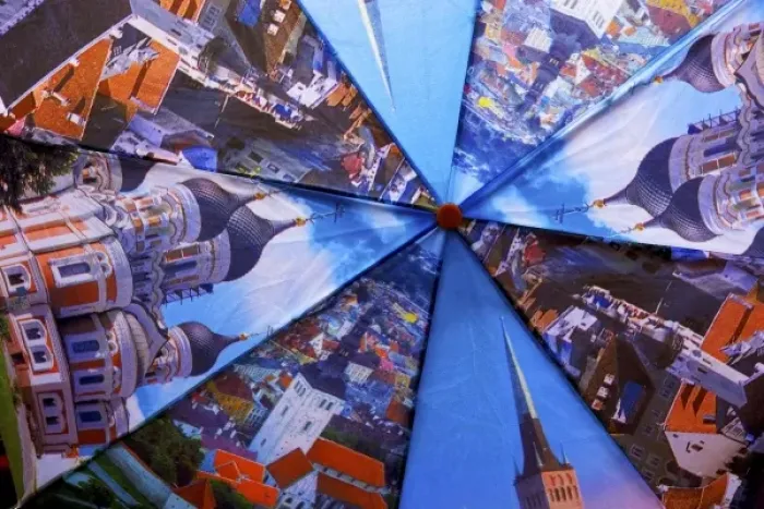 Framed Print : Estonia, Tallinn. Open umbrella showing city scenes in Tallinn
