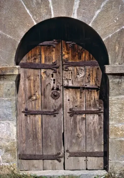 Framed Print : Europe, Andorra. An ancient old wooden door contrasts against a stone building in Andorra