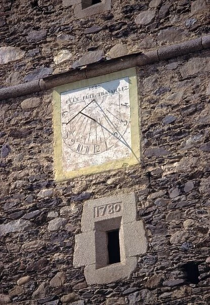 Europe, Andorra. An old sun dial adorns a stone tower in Andorra