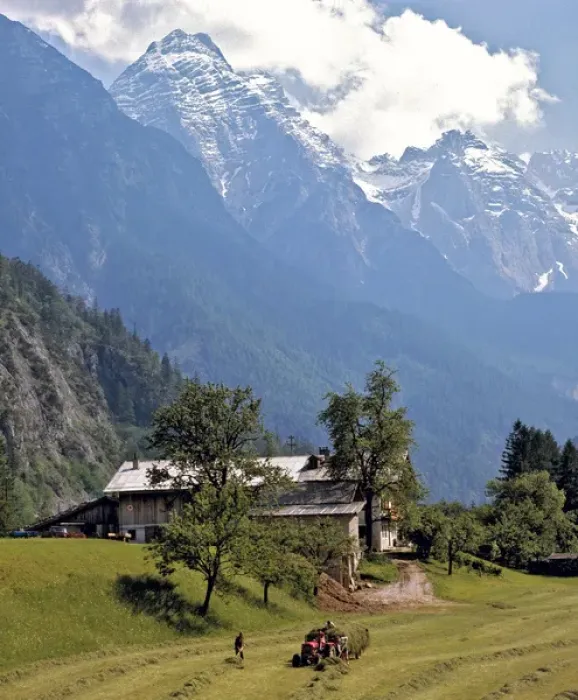 Framed Print : Europe, Austria, Inn River Valley. The Tuxer Alps look down on this haying scene