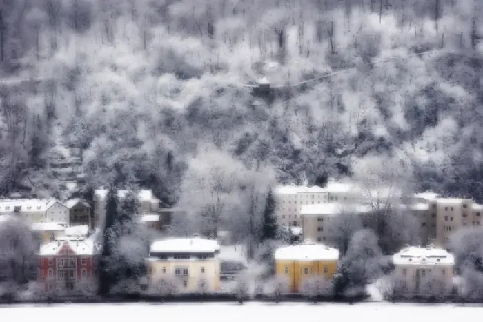 Framed Print : Europe, Austria, Salzburg. Dreamlike view of residences and snow-covered trees on hillside