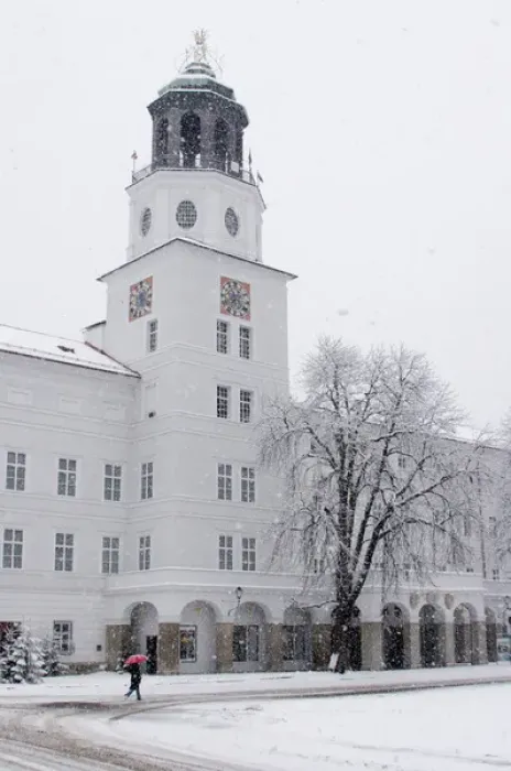 Framed Print : Europe, Austria, Salzburg. Person in snowstorm with red umbrella walking past white building Framed Print : Europe, Austria, Salzburg. Person in snowstorm with red umbrella walking past white building