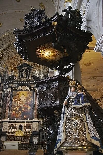 Europe, Belgium, Antwerp. A Madonna and Child statue stands by an ornate oak pulpit