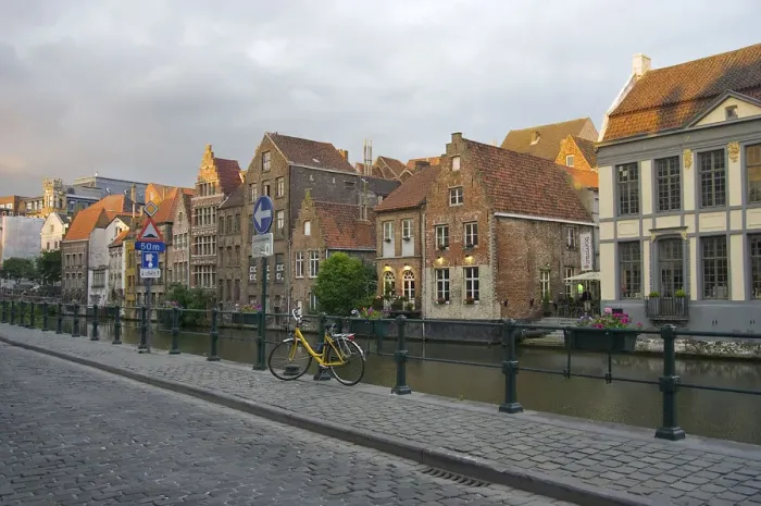 Framed Print : Europe, Belgium, Ghent. A bicycle parked on a paved-stone sidewalk by the water Framed Print : Europe, Belgium, Ghent. A bicycle parked on a paved-stone sidewalk by the water