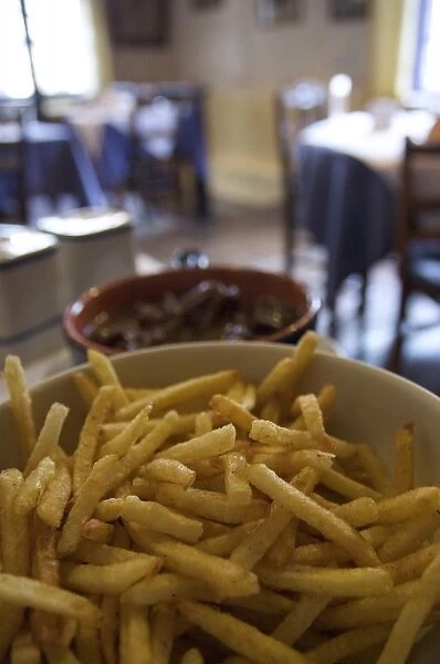 Europe, Belgium, Ghent. A bowl of fries served in a traditional Belgian restaurant