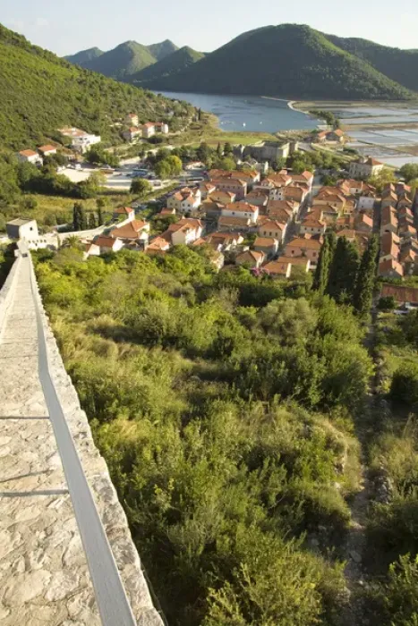 Framed Print : Europe, Croatia, Dalmatia, Mali Ston. Salt pans, lush hills and village of Mali Ston