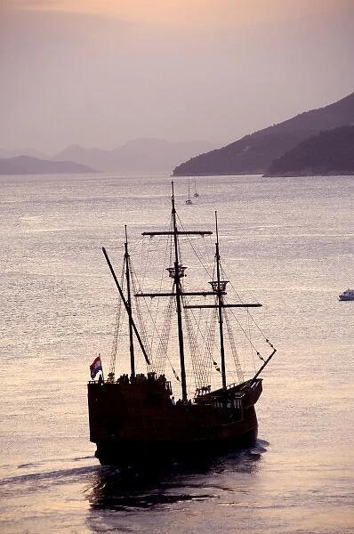 Europe, Croatia. Sight seeing tall ship in the port of Dubrovnik at sunset