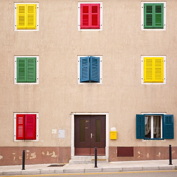 Europe, Croatia, Vrsar. Building with colorful shutters