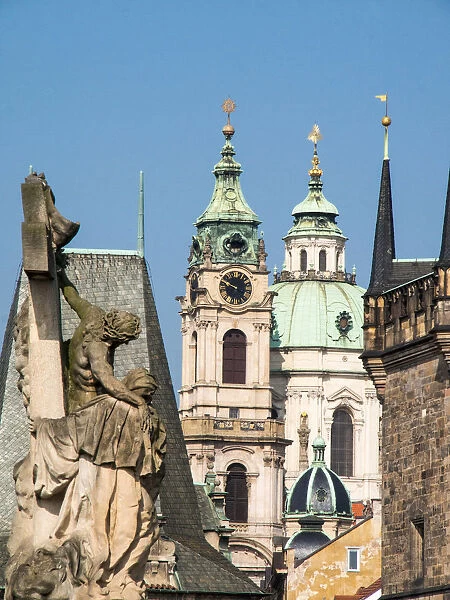 Europe, Czech Republic, Prague. Statue on the Charles bridge and the St. Nicholas church