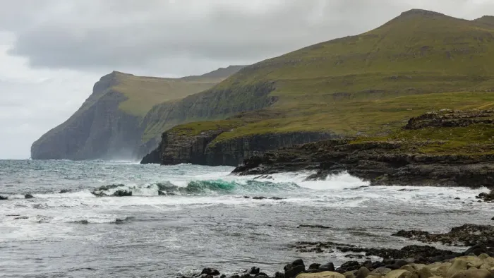 Framed Print : Europe, Faroe Islands. View of the northern coast pounded by storm surf from the village