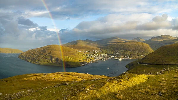 Europe, Faroe Islands. View of the village of Vestmanna with rainbow on the island of