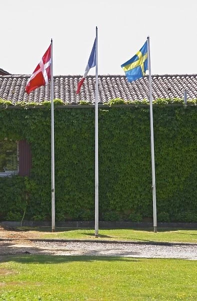 Europe, France. A Danish, French and Swedish flag in front of the chateau