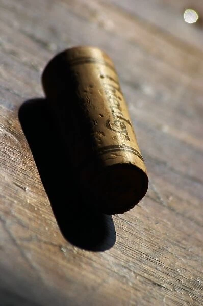 Europe, France. A cork stamped with the name of the chateau on an old wooden