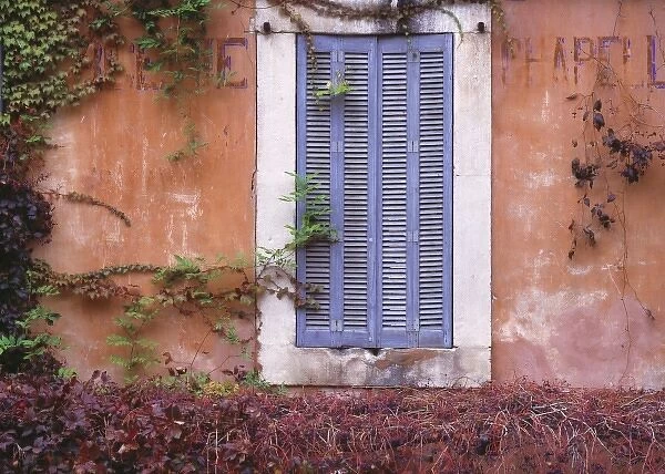 Europe, France, Bonnieux. Colorful shutters cover a window in Bonnieux, Provence, France