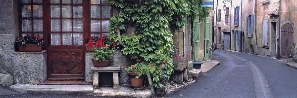 Europe, France, Lourmarin. A quiet street scene in Lourmarin, France, reflects the