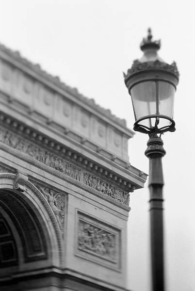 Europe, France, Paris. Arc de Triomphe and streetlamp