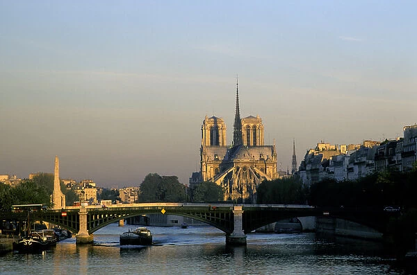 Europe, France, Paris. Notre Dame cathedral and pedestrian foot bridge over River Seine