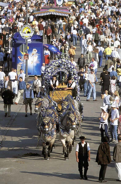 Europe, Germany, Munich. Oktoberfest, horse drawn beer wagon makes its way through crowd
