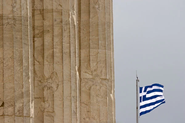 Europe, Greece, Athens, Acropolis. Three pillars of the Parthenon and the Greek flag