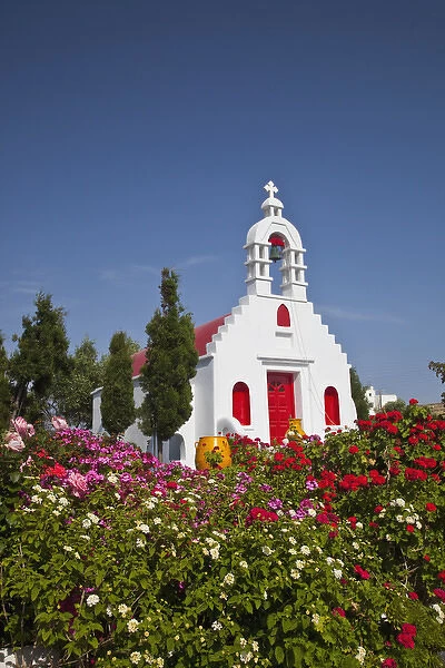Europe, Greece, Greek Island, Mykonos, Chapel with red door and colorful plantings