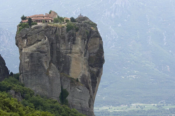 Europe, Greece, Meteora. Agias Triados Monastery perched atop rock pillar. Credit as