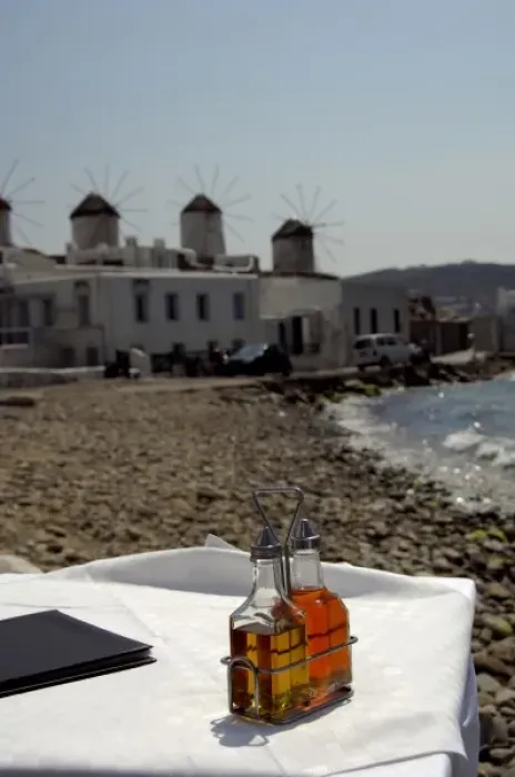 Framed Print : Europe, Greece, Mykonos. Waterfront cafe, historic windmills in distance Framed Print : Europe, Greece, Mykonos. Waterfront cafe, historic windmills in distance