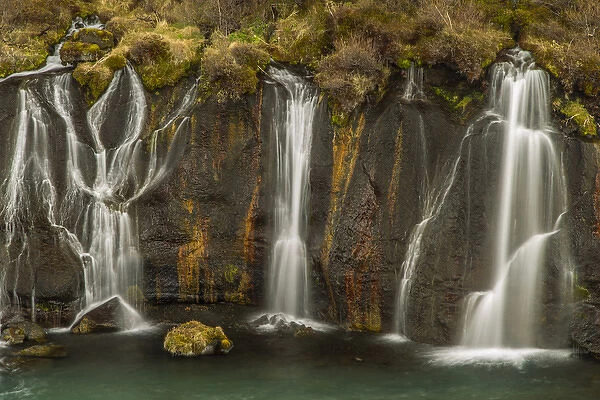 Europe, Iceland, Hraunfossar. Waterfalls flow over igneous rocks