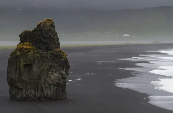 Framed Print : Europe, Iceland, Vik. Basalt column rises from black sand beach on rainy day. Credit as