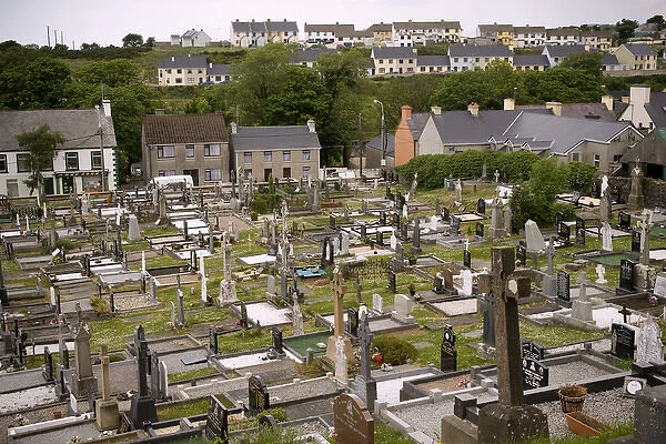 Europe, Ireland, Adara. High overview of the church cemetery and village houses. Credit as