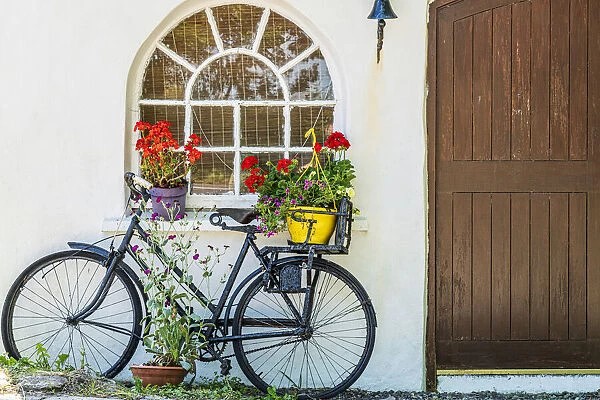 Europe, Ireland, County Cork. Bicycle next to house with potted plants