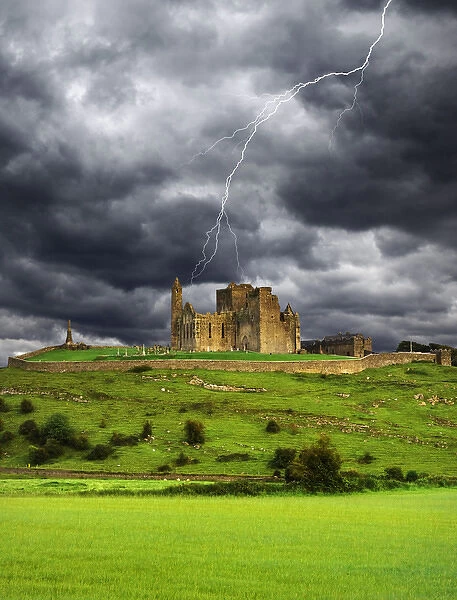 Europe, Ireland, County Tipperary. Lightning over ruins of the Rock of Cashel. Credit as