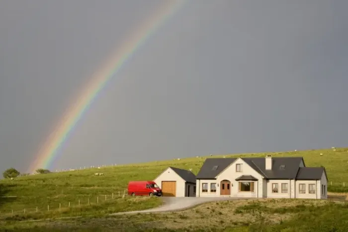 Framed Print : Europe, Ireland, Donegal. Afternoon rainbow arcs across the sky over a house in