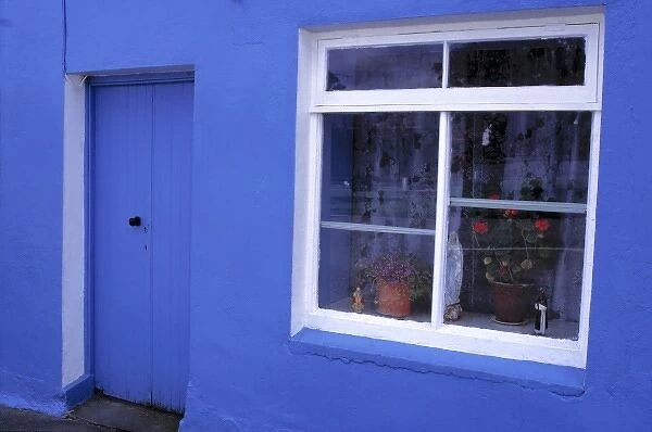 Europe, Ireland, RIng of Kerry. This blue house with its white-paned window is found