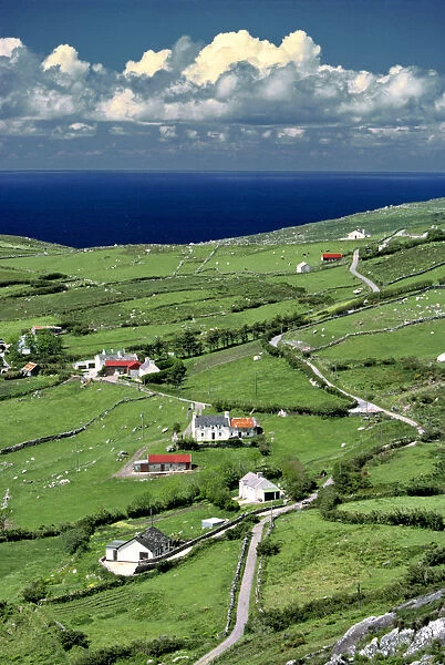 Europe, Ireland, Ring of Kerry. Red-roofed homes interrupt the green of Ring of Kerry
